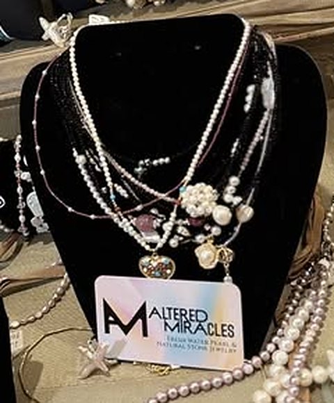Layered pearl necklaces on a black velvet bust